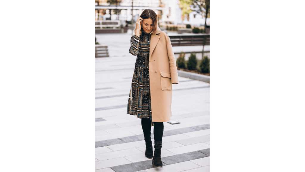 Attractive woman wearing a beige coat outdoors in a park