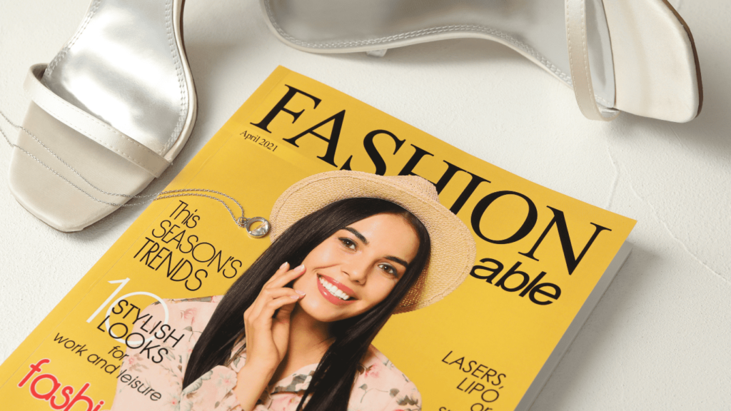 Fashion magazine, footwear, and accessories showcasing various fashion sense, artfully displayed on a white table.