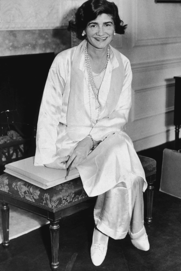 Iconic figure Coco Chanel depicted in a monochrome ensemble