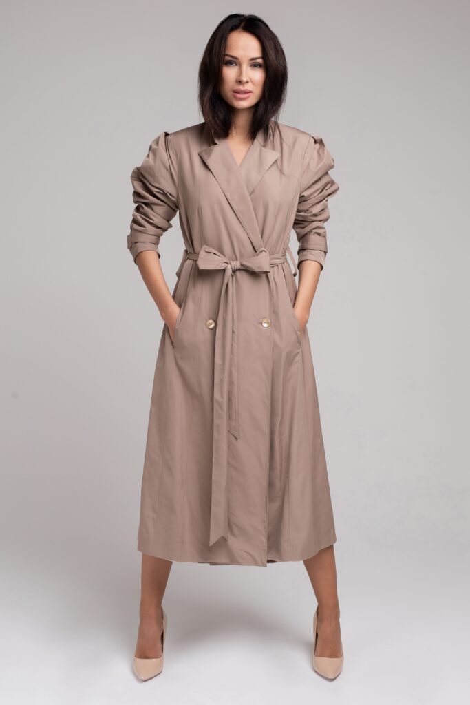 Photo full length of beautiful brunette young woman wearing long trench coat against grey background. fashion and style concept