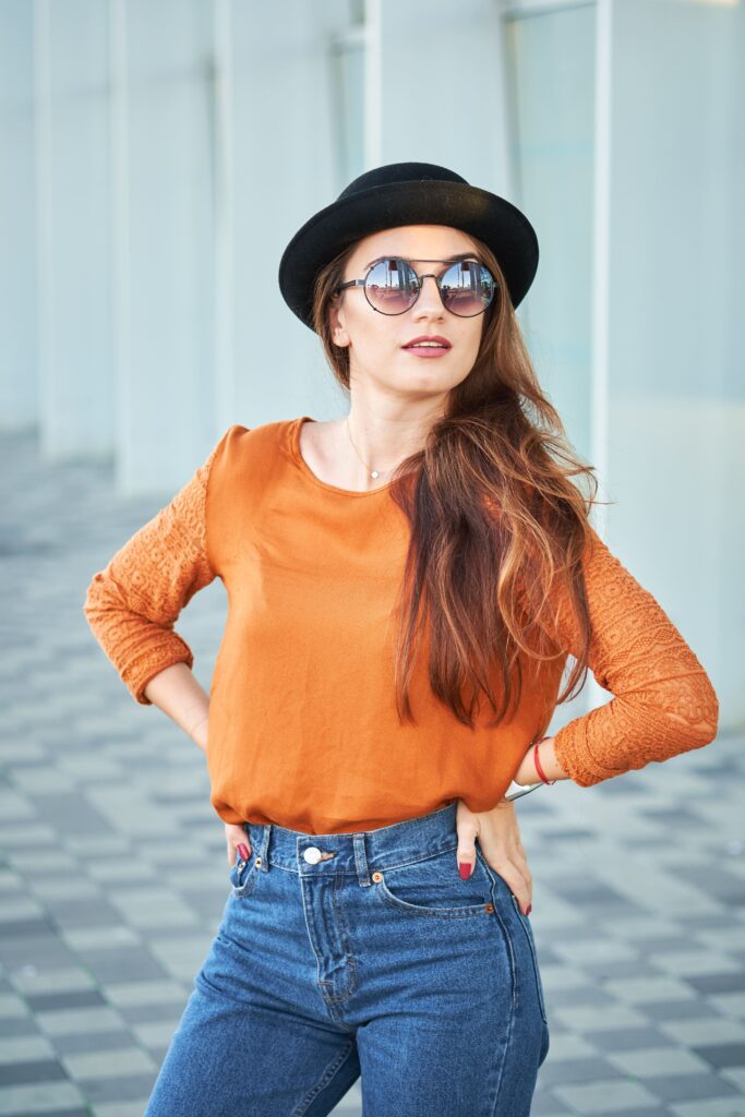 A portrait of a fashionable young woman wearing an orange and blue outfit.