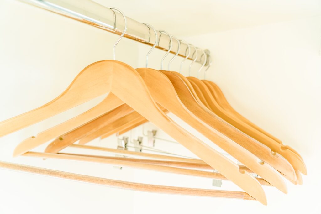 Wooden clothing rack with a single group of garments