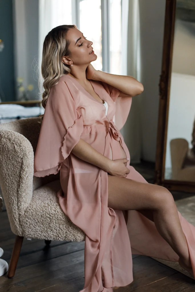 An image of a stylishly dressed pregnant woman looking beautiful in her maternity clothing.