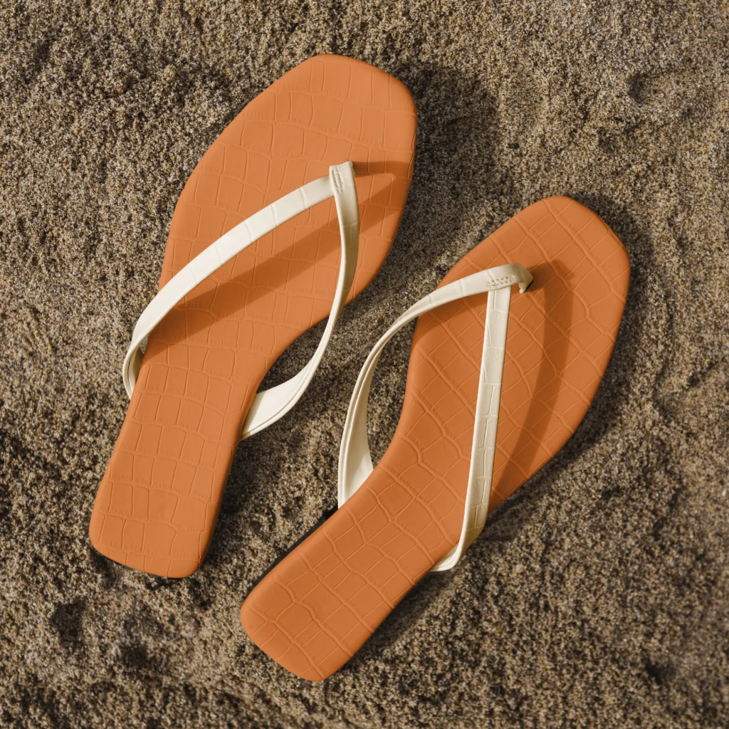 Free photo sandals on the beach summer fashion aerial view