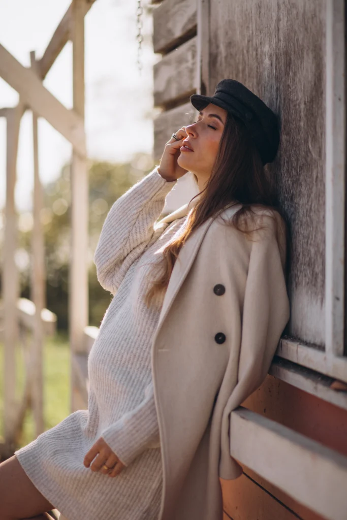 A young pregnant woman waiting for her baby, wearing a stylish maternity outfit suitable for a date night.