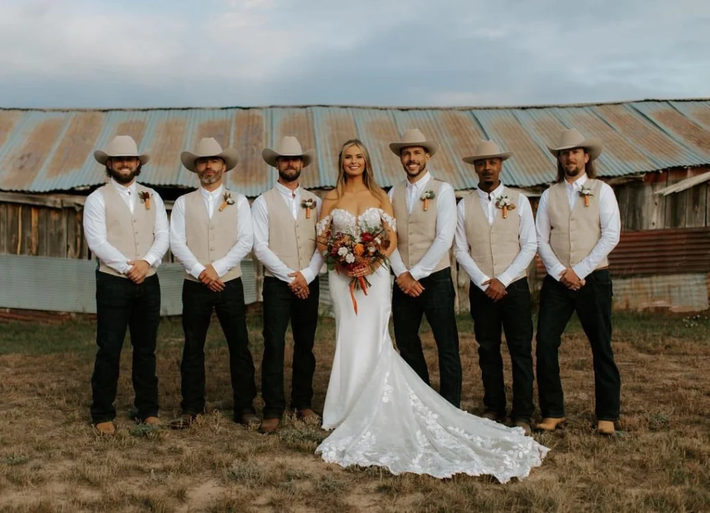 Celebratory image from a cowboy-themed wedding, featuring guests in western-style wedding attire.