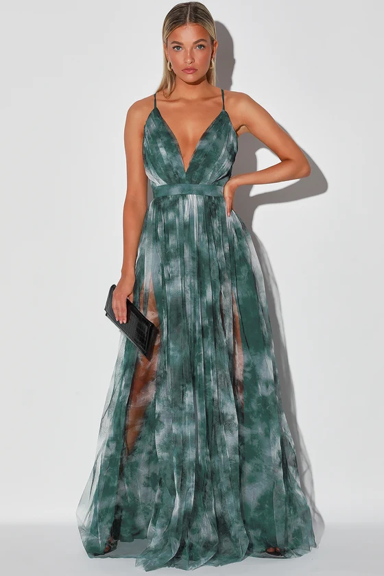 Woman in a green floral dress, embodying a tropical wedding theme, perfect for a casual or beach wedding event.