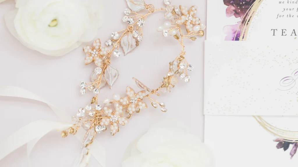 Wedding Invitations and Bridal Accessory on Table with Flowers Flatlay