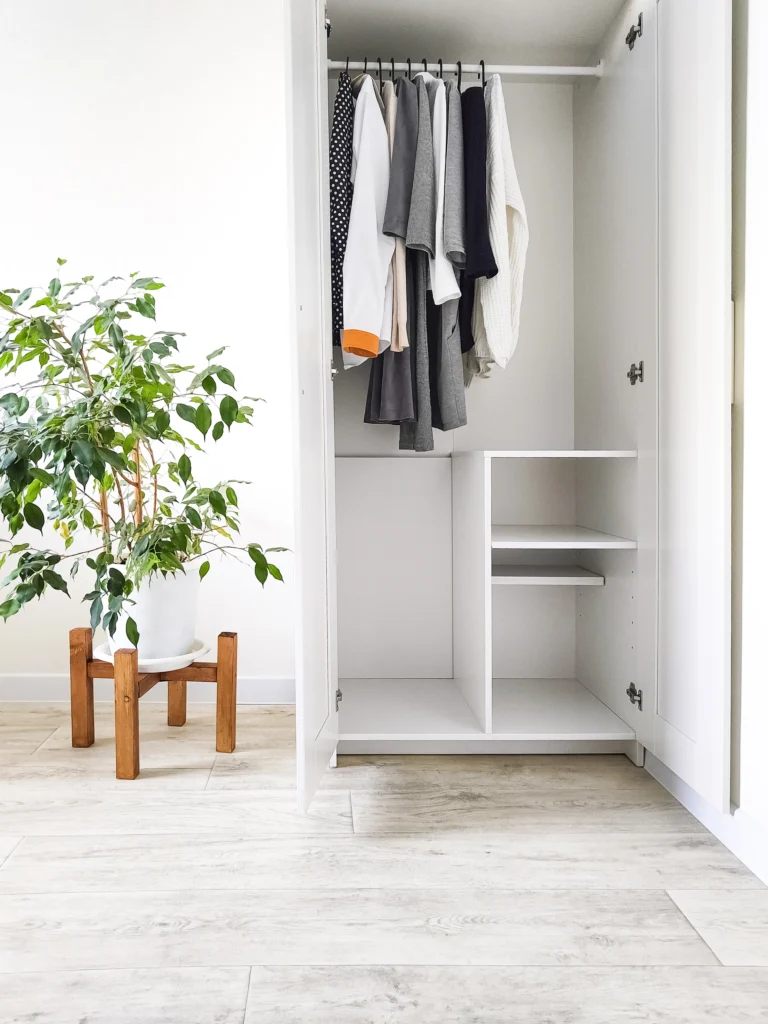Photo wardrobe with basic clothes in room scandi interior neutral colors white black beige