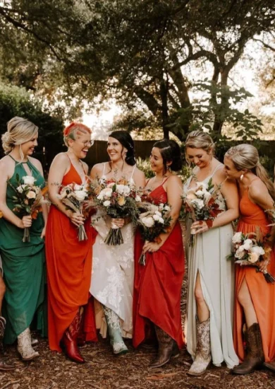Cohort of ladies donned in varied wedding guest attire, captured in a photograph while holding bouquets.