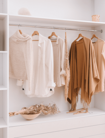 Capsule wardrobe displaying a curated selection of stylish female clothing items, organized for easy access and mixing.