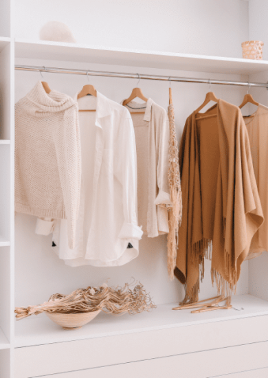Capsule wardrobe displaying a curated selection of stylish female clothing items, organized for easy access and mixing.
